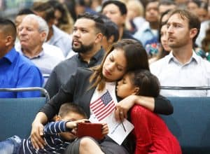 Una mujer inmigrante abraza a un niño y a una niña durante una ceremonia de naturalización el pasado agosto en Los Ángeles, California. (CNS/California)