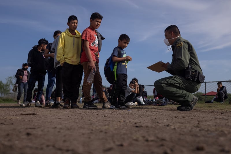 Anderson, a 6-year-old unaccompanied minor from El Salvador, stands in line with other asylum-seeking children in La Joya, Texas, May 14, 2021, as they identify themselves to a Border Patrol agent after crossing the Rio Grande from Mexico. (CNS photo/Adrees Latif, Reuters)