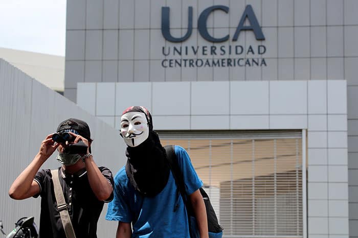 Un manifestante usa binoculares durante una protesta contra el gobierno del presidente nicaragüense Daniel Ortega frente a la Universidad Centroamericana dirigida por jesuitas en Managua el 1 de octubre de 2018. La universidad sufrió recortes presupuestarios después de las protestas. (Foto CNS/Oswaldo Rivas, Reuters)