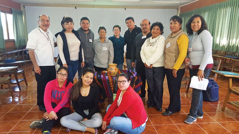 Rosario Miranda (suéter color crema con bordados), otros participantes y el Padre Zúñiga se unieron a un taller ESPERE en 2018, en el Centro Misionero Maryknoll en Cochabamba, Bolivia. (Cortesía del Juan Zúñiga/Bolivia)