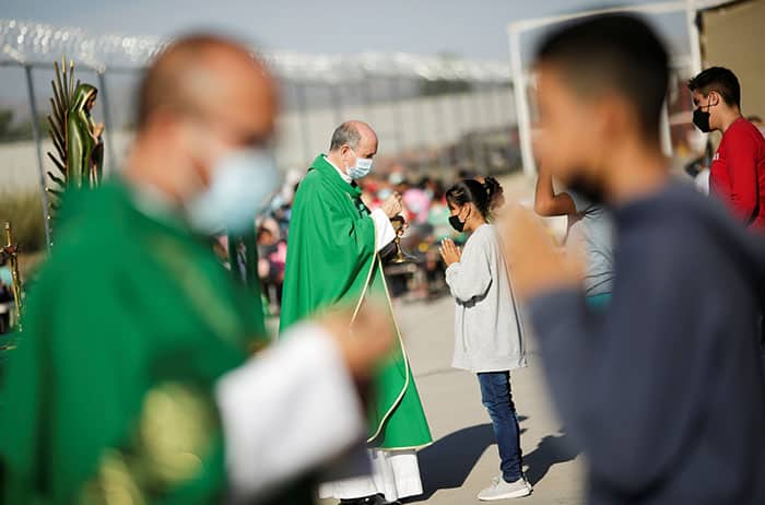 After World Mission Sunday Mass at St. Ferdinand Church, pastor Father Jason Torba and Cardinal Blase Cupich greet the congregation, including all those who do mission in Chicago. (Julie Jaidinger, Chicago Catholic/U.S.)