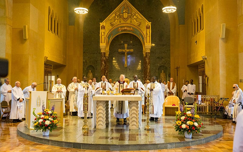 After World Mission Sunday Mass at St. Ferdinand Church, pastor Father Jason Torba and Cardinal Blase Cupich greet the congregation, including all those who do mission in Chicago. (Julie Jaidinger, Chicago Catholic/U.S.)