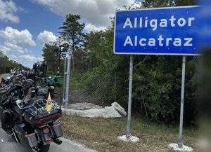 Las motocicletas del arzobispo Thomas G. Wenski de Miami y miembros de Knights on Bikes están estacionadas frente a la entrada de "Alligator Alcatraz", un centro de detención de inmigrantes a unos 88 kilómetros de Miami, en los Everglades de Florida. El arzobispo y sus compañeros motociclistas se detuvieron para rezar el rosario por los detenidos el 20 de julio de 2025. (OSV News/Arzobispo Thomas G. Wenski)
